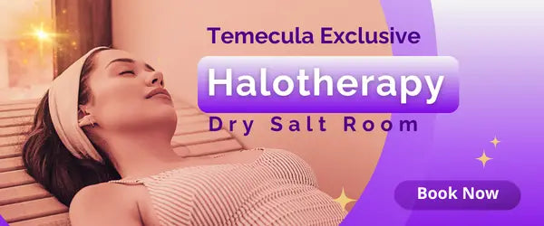 Woman in relaxed pose inhaling salt particles in a halotherapy salt cave.