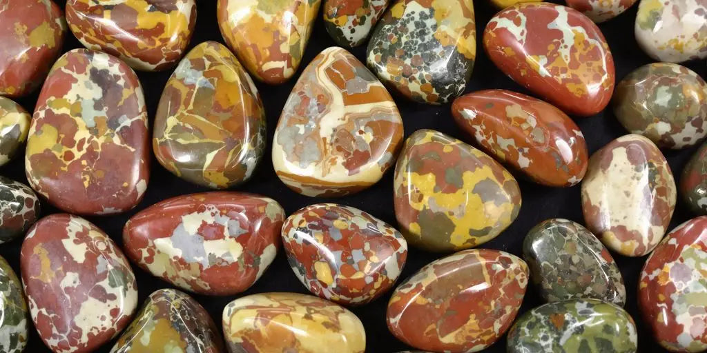 Colorful polished jasper crystals on a dark surface