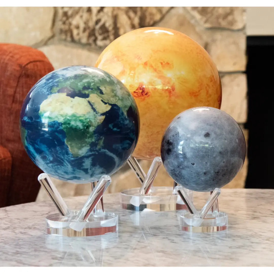 Mova Globe displaying Earth, sun, and moon, illustrating celestial mechanics and spiritual energy.