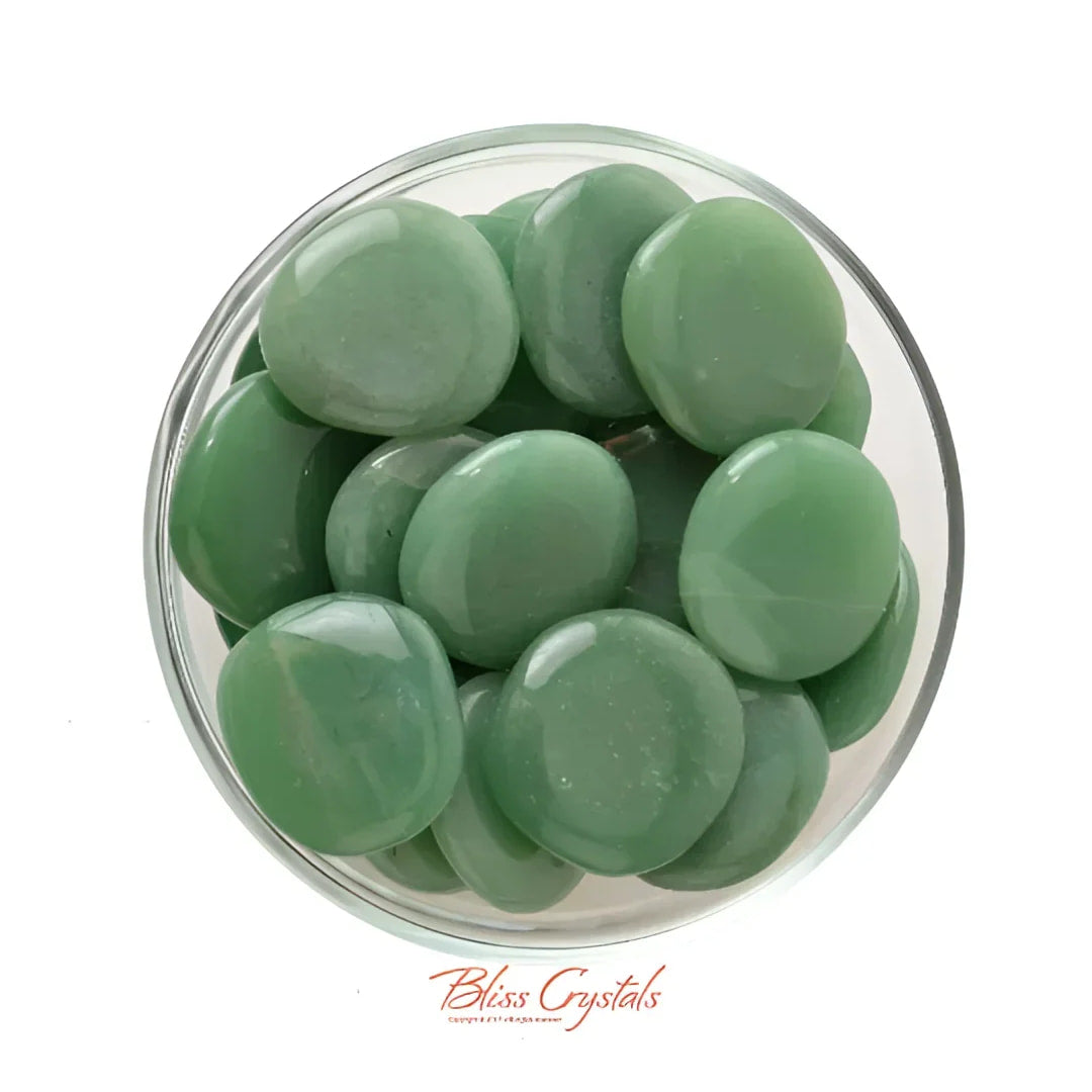 Green sea glass pebbles in a bowl with a Medium Green Aventurine Palm Stone #RA14