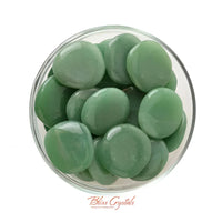 Green sea glass pebbles in a bowl with a Medium Green Aventurine Palm Stone #RA14