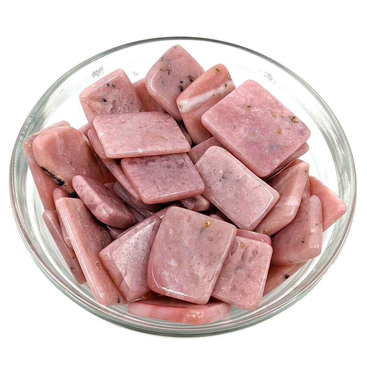 Bowl of raw pork pieces next to Pink Opal Polished Slice for unique cooking use