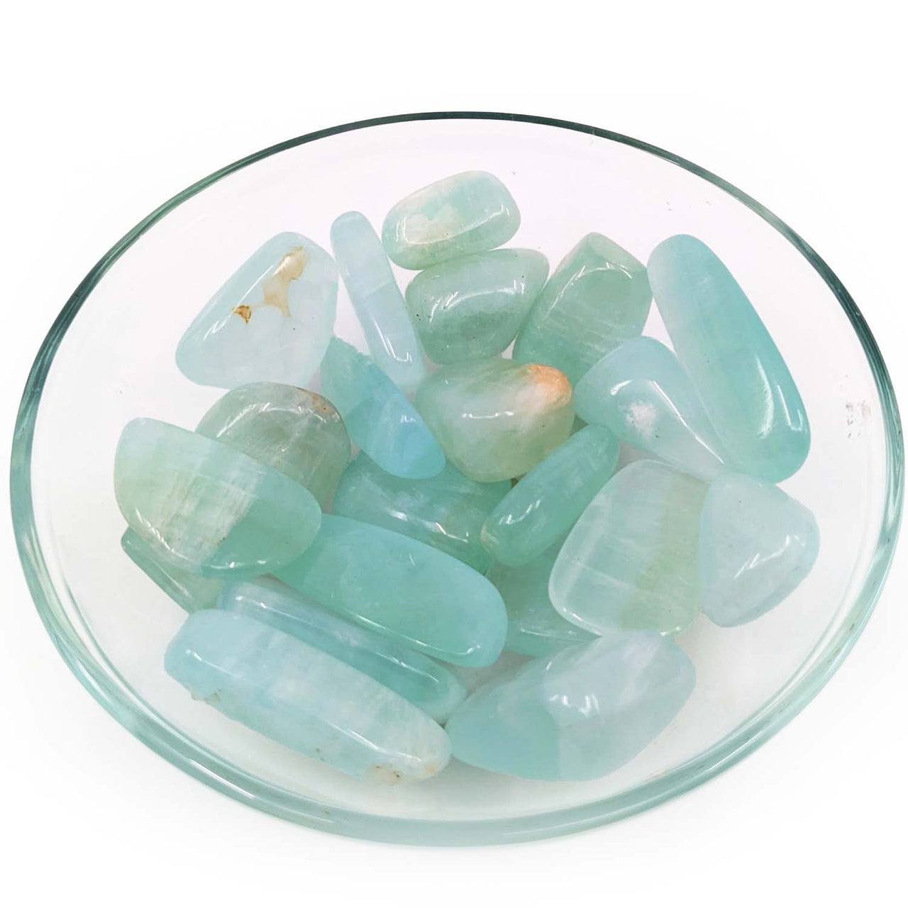 Polished aqua-colored aventurine stones in a glass dish with Pistachio Calcite