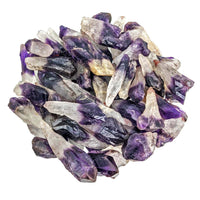 Amethyst Cacoxenite crystals in a glass bowl showcasing mixed size rough points