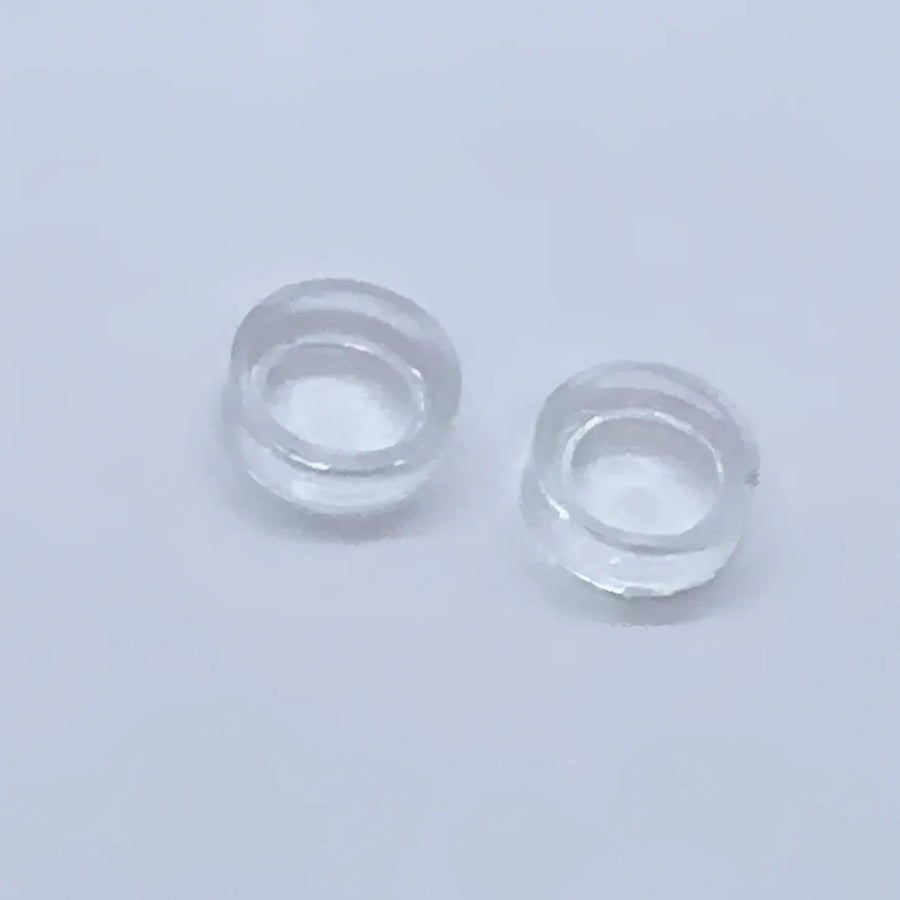 Two clear contact lenses displayed on an Acrylic & Metal Deep Easel Stand #Q152