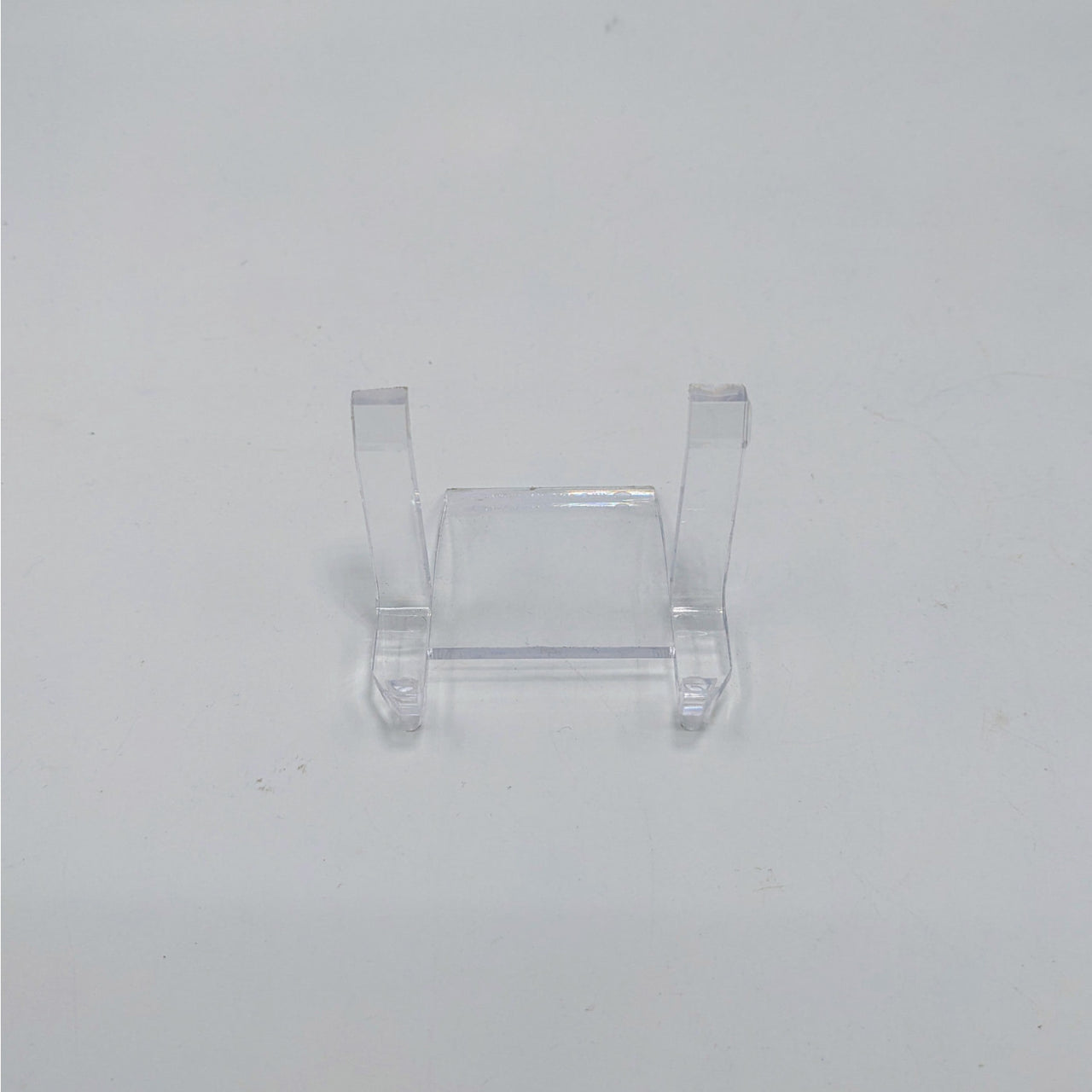 Clear plastic display stand with two supports for showcasing ring holder or art