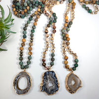 Three beaded necklaces with Agate pendants displayed in African Turquoise and Jasper design