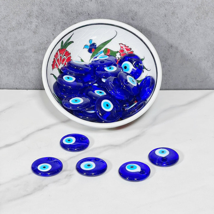 Decorative blue evil eye glass beads in a ceramic plate for mystical protection