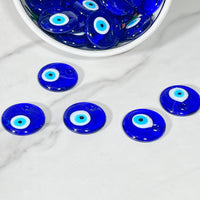 Blue evil eye glass bead with white and light blue concentric circles for protection