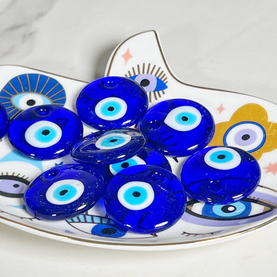 Blue glass evil eye amulets on a decorative plate for All Seen Evil Eye Glass Bead