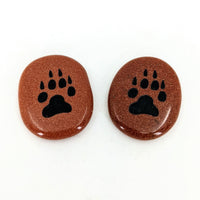 Animal Palm Stone #T389D with two brown and black paw prints on a white background