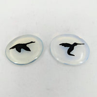 Pair of intricate bird engravings on Animal Palm Stone #T389D against a white backdrop