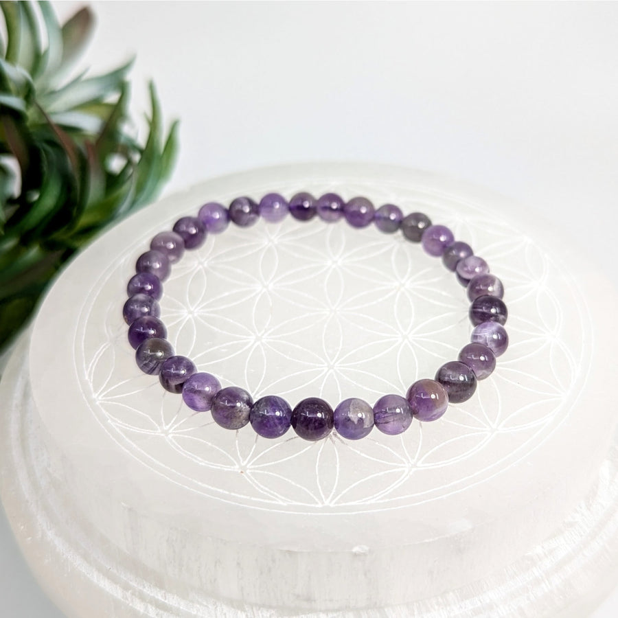Purple beaded bracelet featuring Amethyst stones in a Banded Amethyst 7-inch 6mm Bead Bracelet