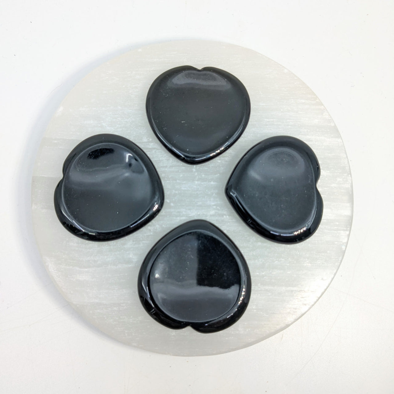 Selenite plate with black heart-shaped stones Black Obsidian 1.5’’ Thumb Heart Stone