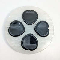 Selenite plate with black heart-shaped stones Black Obsidian 1.5’’ Thumb Heart Stone