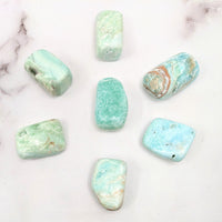 Blue Aragonite tumbled stones on a marble surface #SK9735 - green and blue polished gems