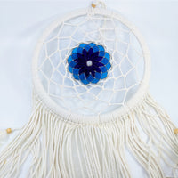 White crochet dreamcatcher with blue stained glass flower design and flowing tassels
