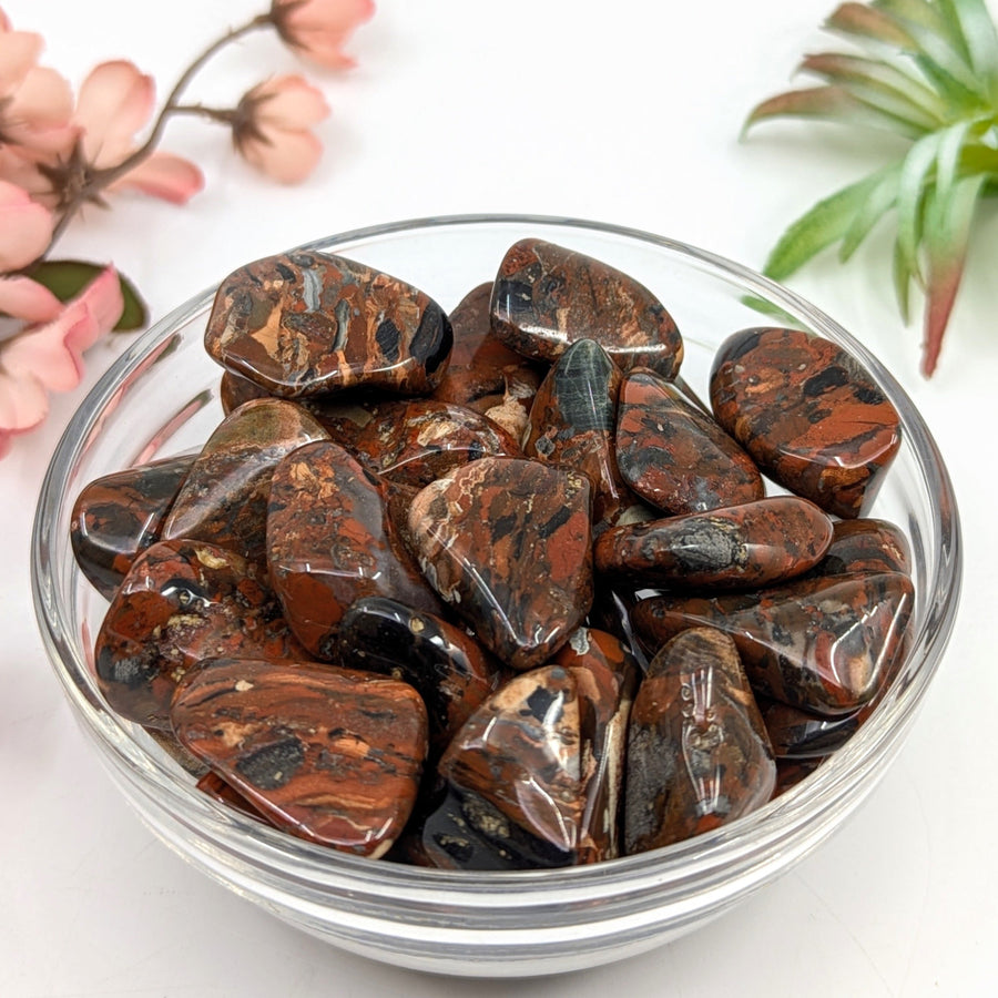 Polished brecciated jasper stones in a glass bowl, an energizing stone with stability-giving properties