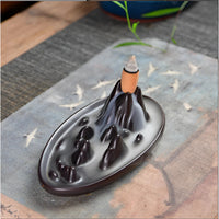 Black ceramic backflow incense burner shaped like a mountain peak with flowing smoke design LV9473