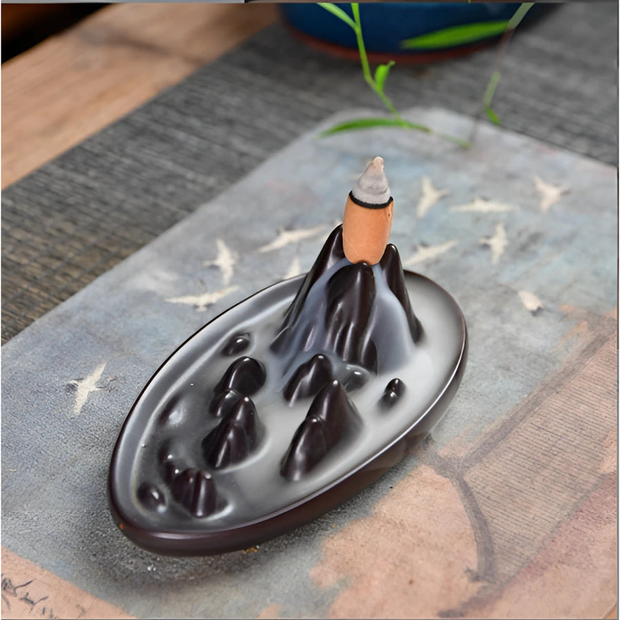 Black ceramic backflow incense burner shaped like a mountain peak with flowing smoke design LV9473