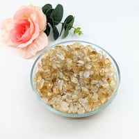 A radiant bowl of yellow citrine crystals paired with a rose, featured as Citrine Fire & Ice Gravel