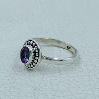 Oval faceted citrine or peridot sterling silver ring with iridescent purple gemstone and beaded bezel