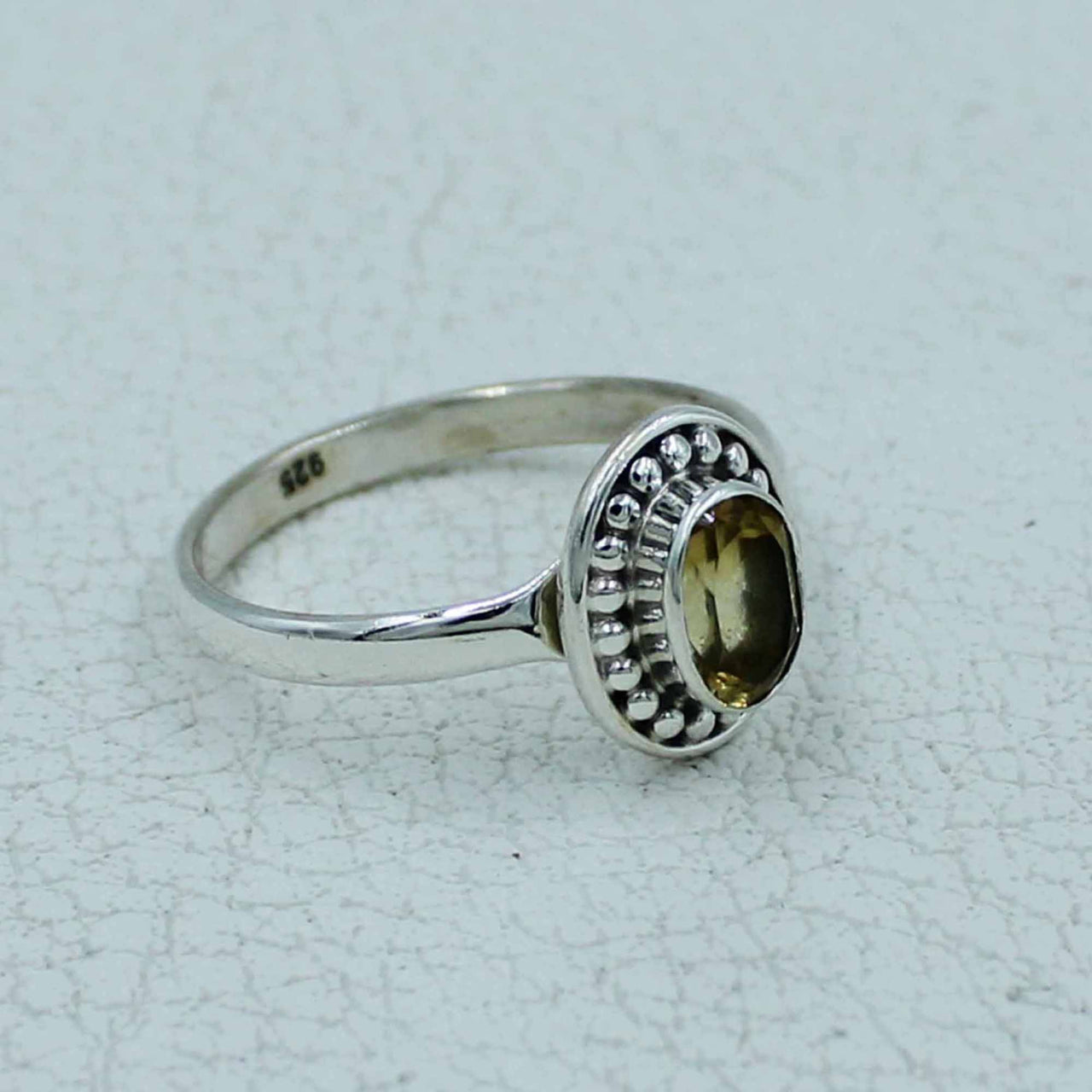 Oval citrine or peridot faceted sterling silver ring with beaded bezel