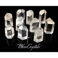 Clear quartz generator points arranged with Bliss Crystals text below for energy healing