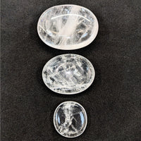 Three polished Clear Quartz palm stones arranged vertically for energy and clarity
