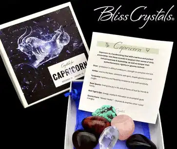 Collection of crystals and stones displayed alongside a Capricorn zodiac card and information sheet.