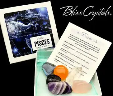 Collection of crystals and stones alongside a Pisces zodiac card and what appears to be an informational paper.