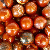 Shiny reddish-brown marbles with swirling patterns in Crystal Marble S015 Rose Quartz decor