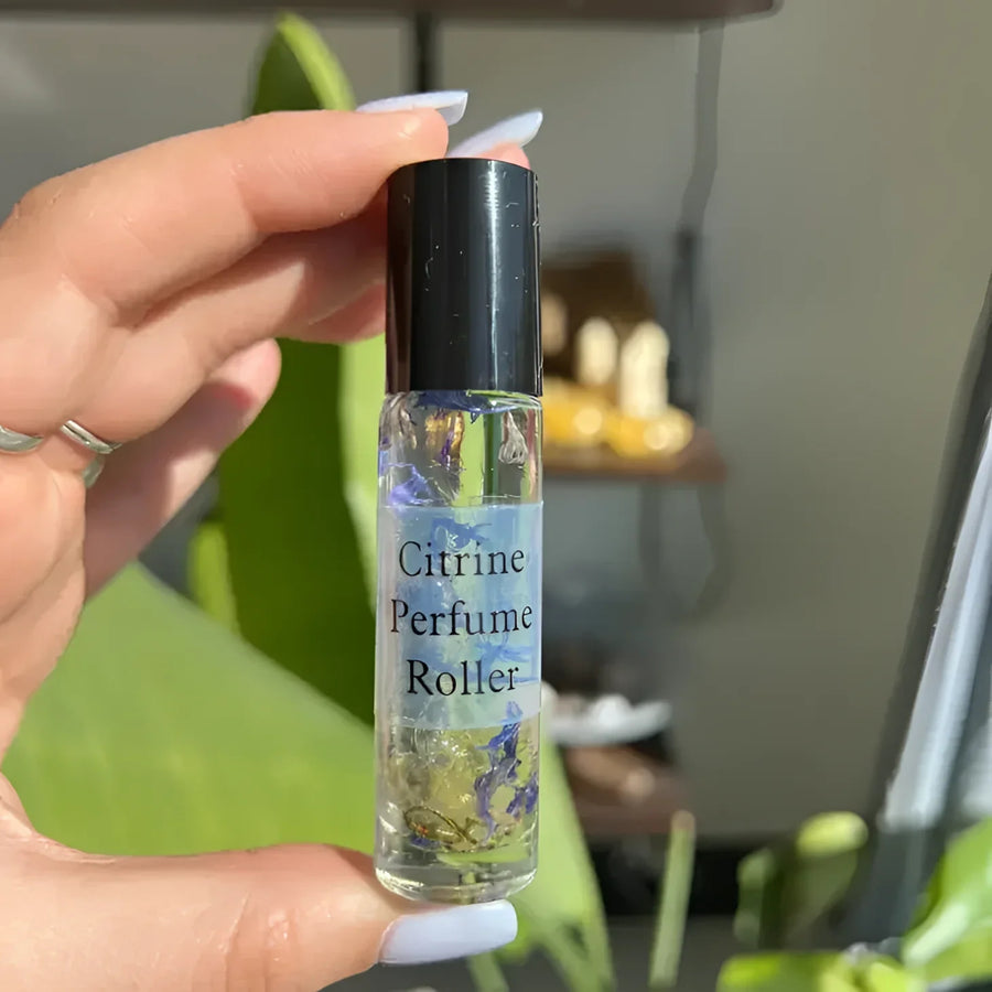 Hand holding Crystal Perfume 10ml Roller #Q217 bottle for an elegant scent experience
