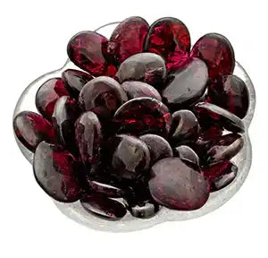 Deep red glass beads or stones arranged in a cluster.
