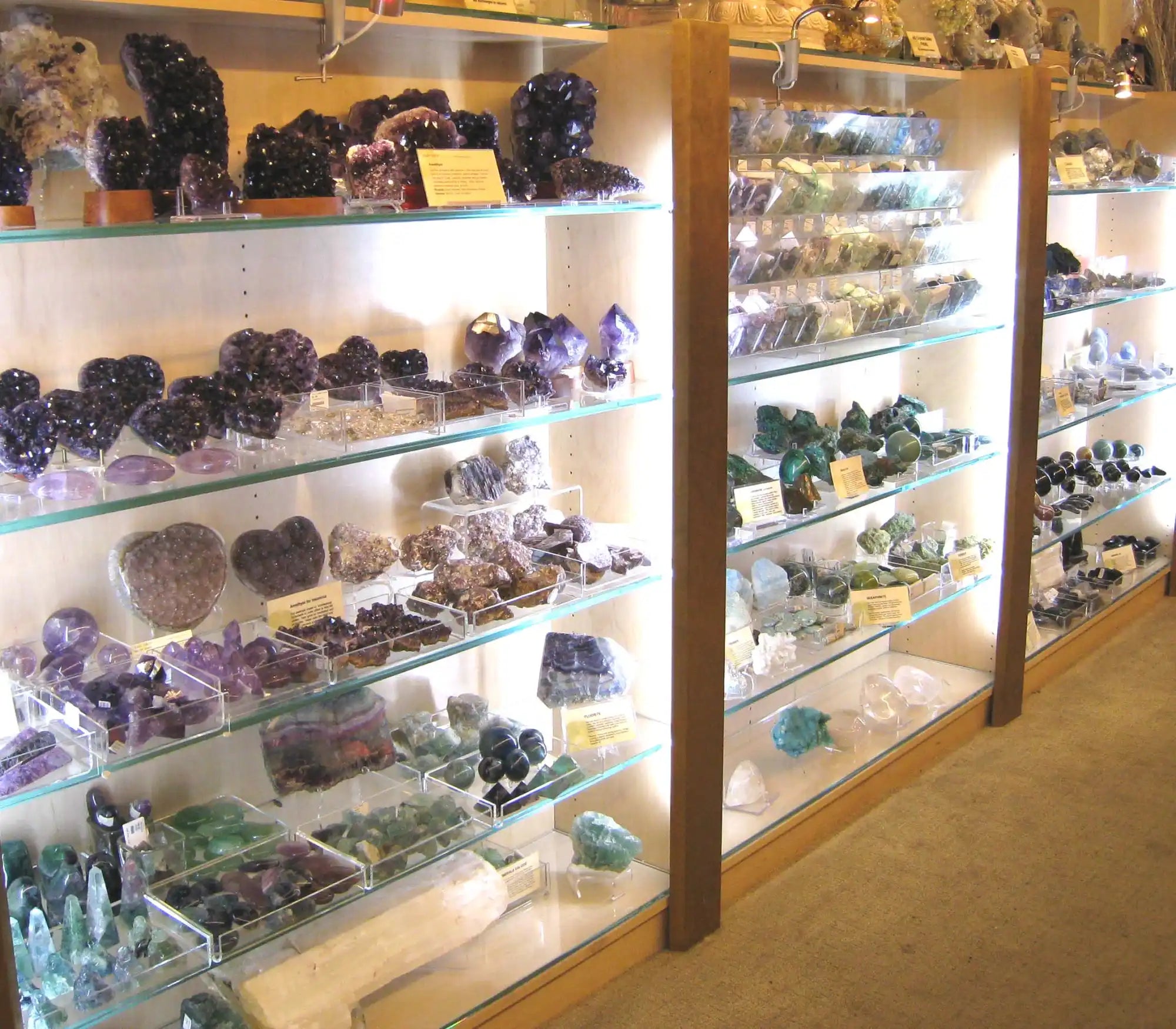 Display cases filled with crystals and mineral specimens on glass shelves.
