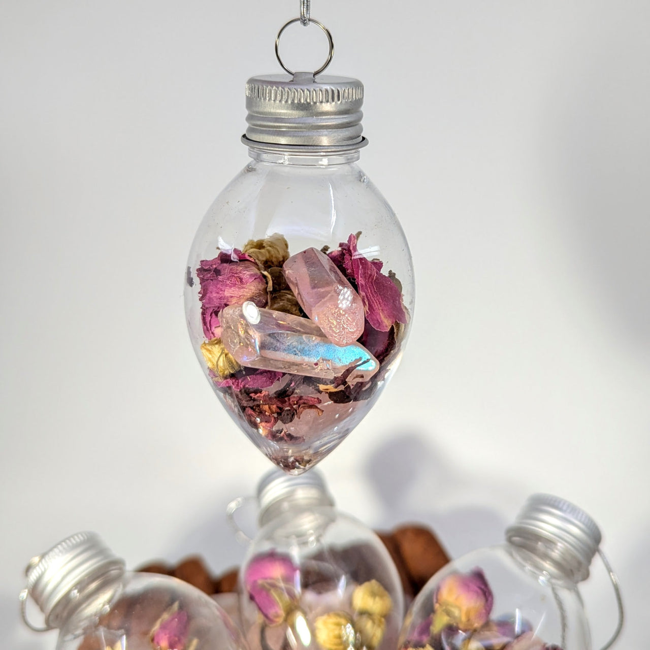 Dreamer’s Heart ornament with pink/yellow petals and quartz crystals