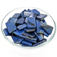 Rough deep blue Lapis Lazuli stones in a glass dish for Dumortierite Grade AA Slice