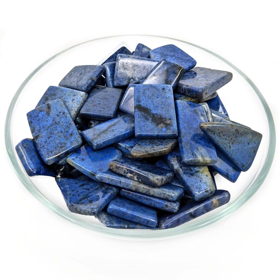 Rough deep blue Lapis Lazuli stones in a glass dish for Dumortierite Grade AA Slice