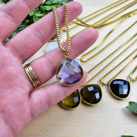 Hand holding gold Faceted Teardrop Amethyst Necklace LV9394