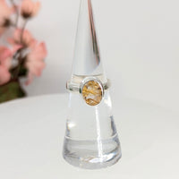 Silver ring with golden rutile gemstone featuring gold rutilated quartz for spiritual growth