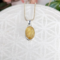 Golden Rutilated Quartz pendant necklace with oval faceted silver setting