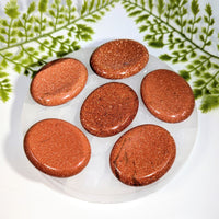 Six 2in goldstone thumb stones #BC1237 on clear plate