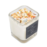 Good Vibes Only ritual soy candle with pink crystals, dried flowers, and herbs in glass vessel