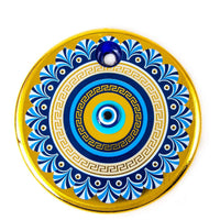 Decorative circular medallion with blue and gold evil eye pattern in handmade gold evil eye wall hanging