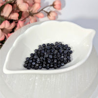 Iolite 4mm round beads with blue-gray sheen in leaf dish
