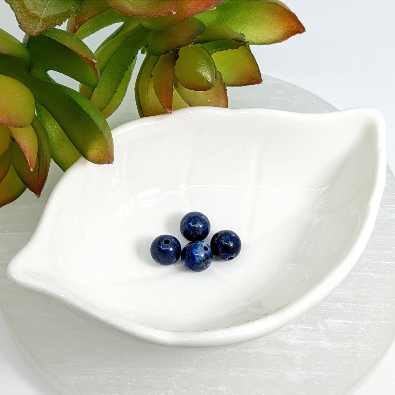 White ceramic leaf-shaped dish with Lapis Dark Blue 8mm round beads