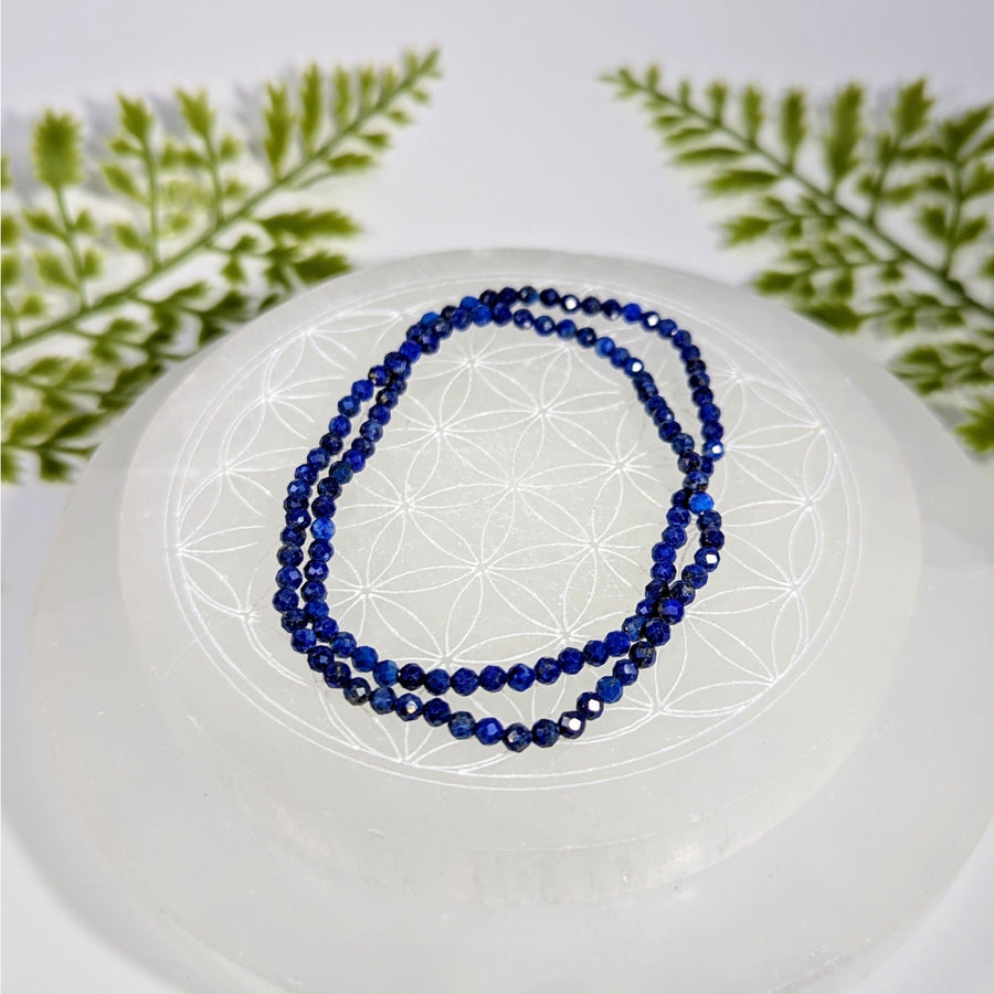 Lapis lazuli 7-inch 3mm faceted bead bracelet on selenite plate