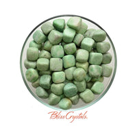 A bowl of green jade pebbles in Mariposite Tumbled Stone aka Green Muscovite #MT12
