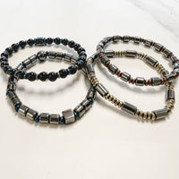 Four beaded hematite gemstone bracelets including Onyx and Tigers Eye sitting together