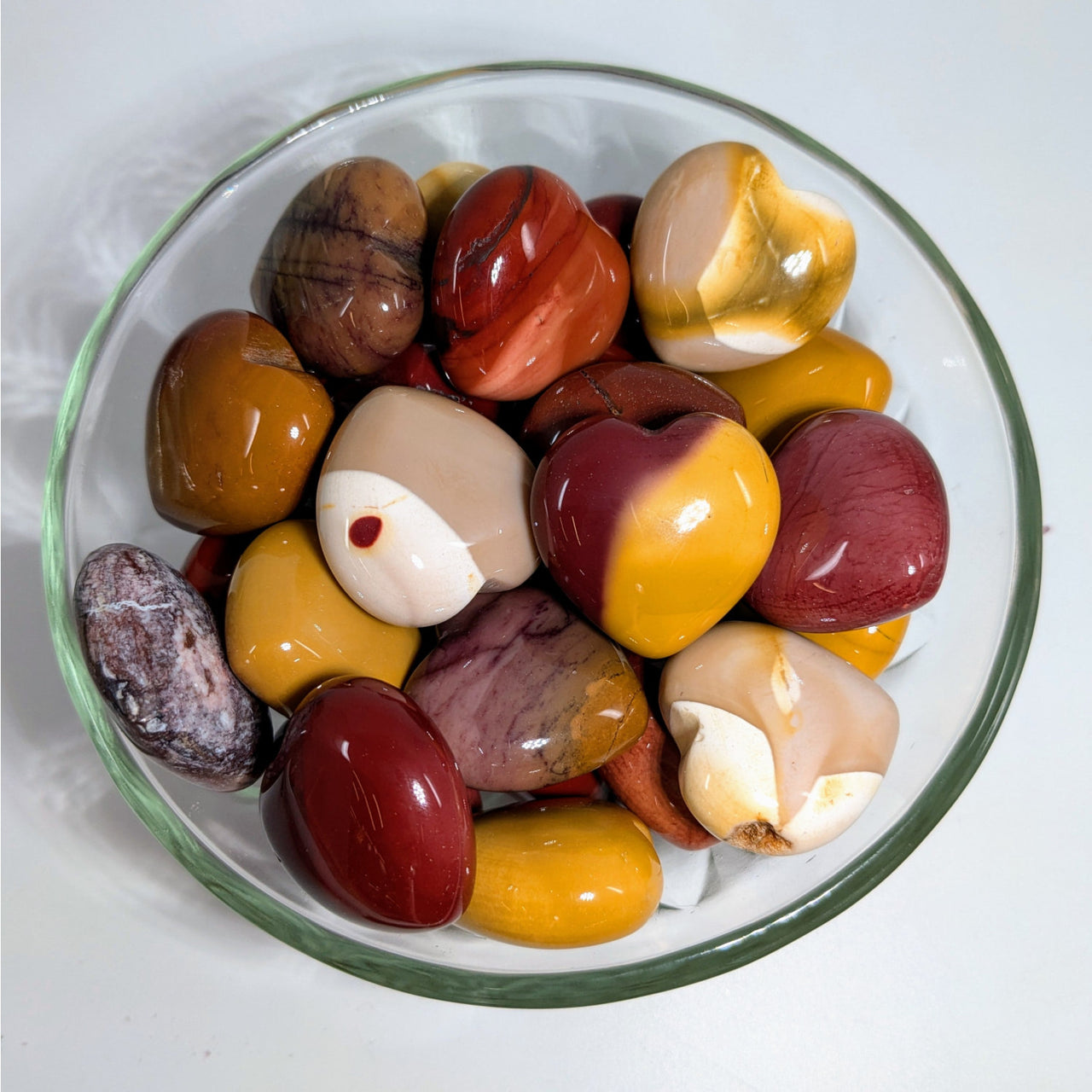 Polished Mookaite Jasper stones in a glass bowl for Mookaite Jasper Hearts H027